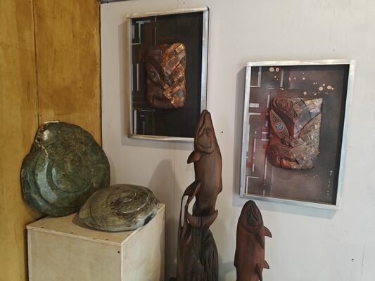 Gallery room with stone carvings and framed works on the walls