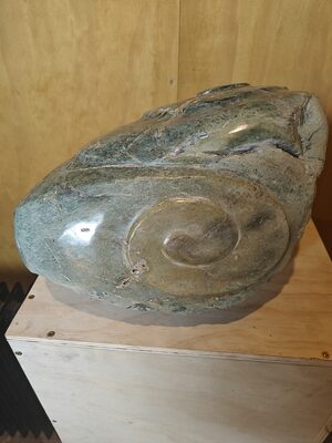 Polished stone carving of a bird on a plinth