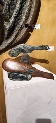 Stone carving with a bird form on a white plinth