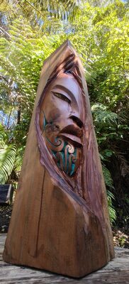 Carved wooden form with a blue painted face
