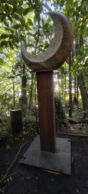 Crescent-shaped carving mounted on a post