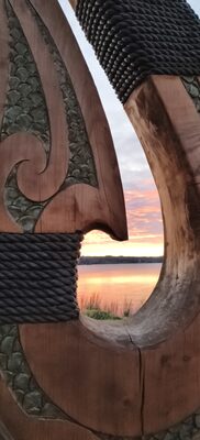 Carved hook with woven detail, close up against the sky