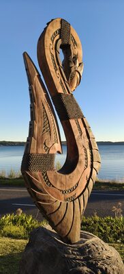 Large carved hook on a rock by the sea